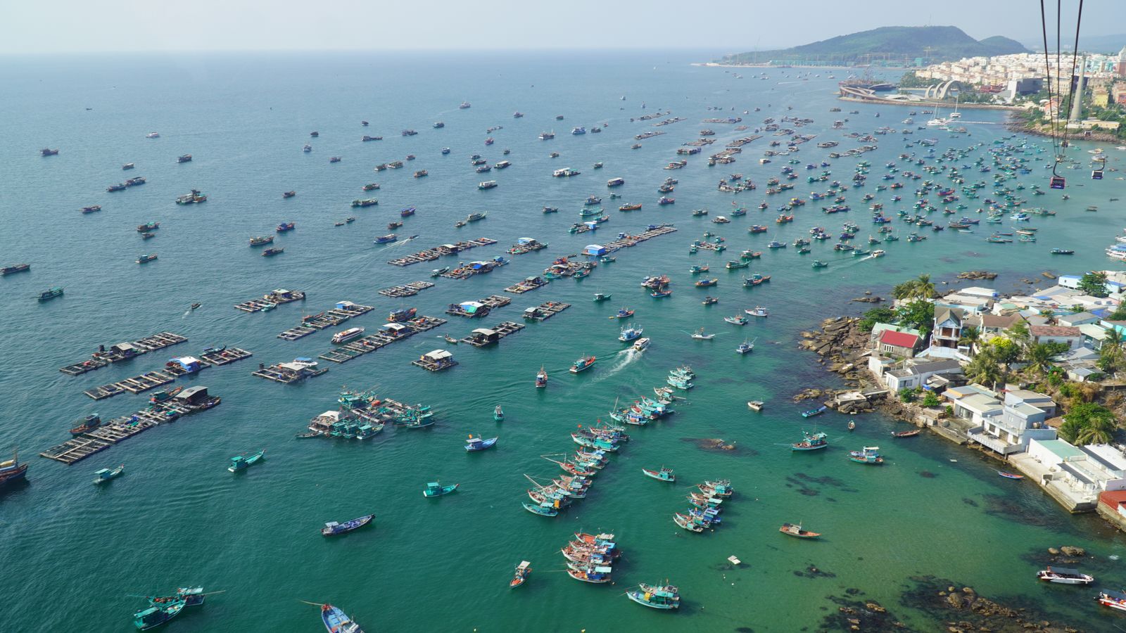 Aerial view of fishing boats scattered across the harbor near Bãi Vòng, Phú Quốc's east coast